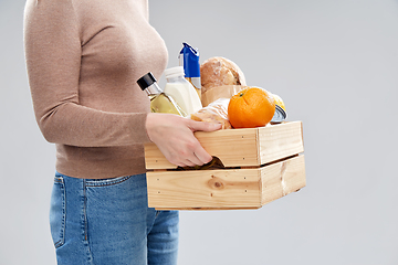 Image showing close up of woman with food in wooden box