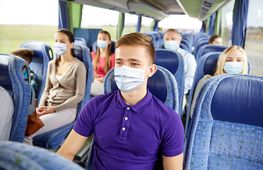 Image showing young man in mask sitting in travel bus or train