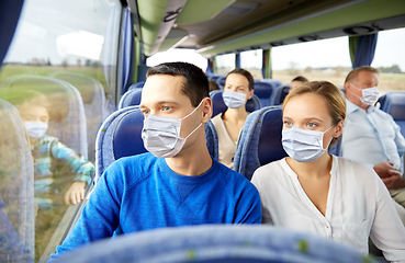 Image showing couple or passengers in masks in travel bus