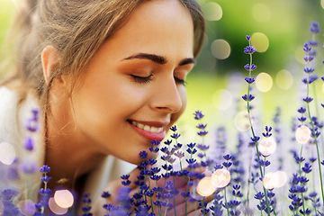 Image showing close up of woman smelling lavender flowers