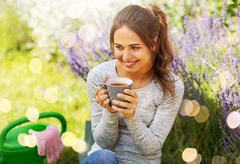 Image showing young woman drinking tea at summer garden