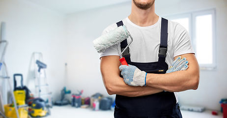 Image showing close up of painter or builder with paint roller