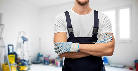 Image showing close up of male builder in overall and gloves