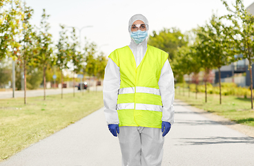 Image showing sanitation worker in hazmat with pressure washer