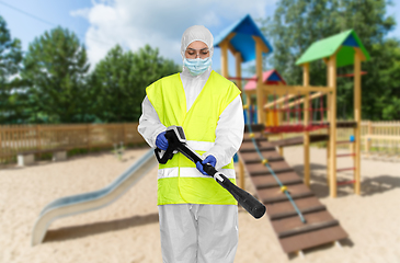 Image showing sanitation worker in hazmat with pressure washer