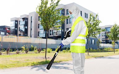 Image showing sanitation worker in hazmat with pressure washer