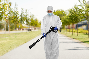 Image showing sanitation worker in hazmat with pressure washer