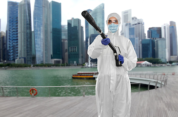 Image showing sanitation worker in hazmat with pressure washer