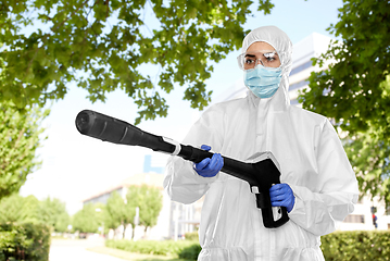 Image showing sanitation worker in hazmat with pressure washer