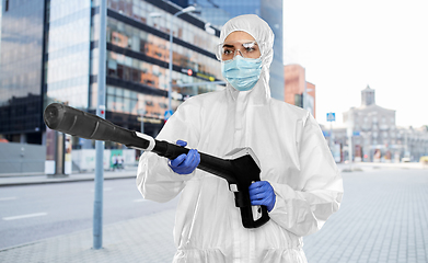 Image showing sanitation worker in hazmat with pressure washer