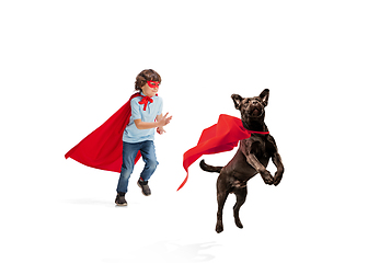 Image showing Child pretending to be a superhero with his super dog isolated on white studio background