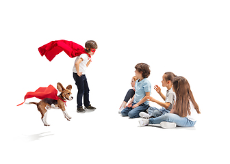 Image showing Child pretending to be a superhero with his super dog and friends sitting around