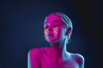 Image showing Tears illustrated of social media activity signs on female face in neon light. Real life versus online lifestyle, addiction to modern technologies