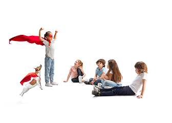 Image showing Child pretending to be a superhero with her super dog and friends sitting around