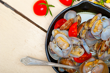 Image showing fresh clams on an iron skillet