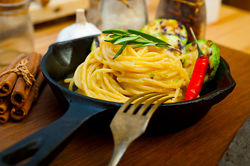 Image showing italian spaghetti pasta with zucchini sauce on iron skillet