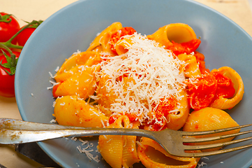 Image showing Italian snail lumaconi pasta with tomatoes