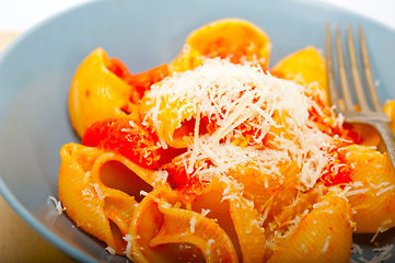 Image showing Italian snail lumaconi pasta with tomatoes