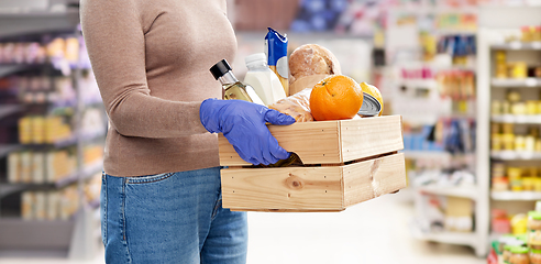 Image showing woman in gloves with food in wooden box