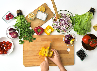 Image showing hands chopping pepper for salad at kitchen