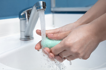 Image showing Woman washing hands carefully in bathroom close up. Prevention of infection and pneumonia virus spreading