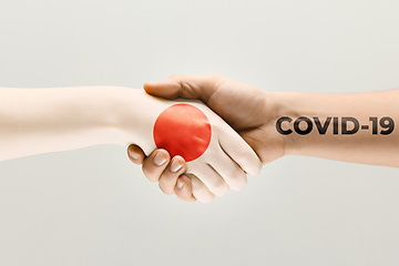 Image showing Human hands colored in flag of Japan and coronavirus - concept of spreading of virus