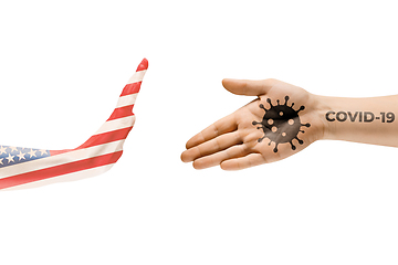 Image showing Stop shaking hands. Human hands colored in flag of USA and coronavirus - concept of spreading of virus