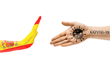 Image showing Stop shaking hands. Human hands colored in flag of Spain and coronavirus - concept of spreading of virus