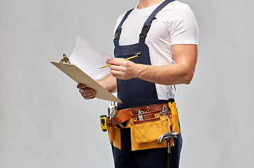 Image showing builder with clipboard, pencil and working tools