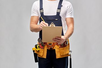 Image showing builder with clipboard, pencil and working tools