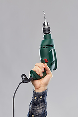 Image showing close up of builder's hand holding drill