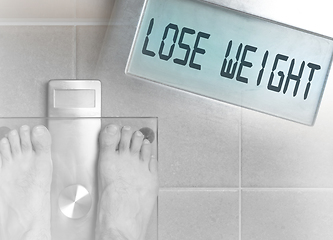 Image showing Man\'s feet on weight scale - Lose weight