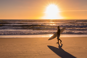 Image showing Surfer walking on the beach