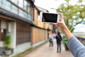 Image showing Woman taking photo with cellphone in kanazawa