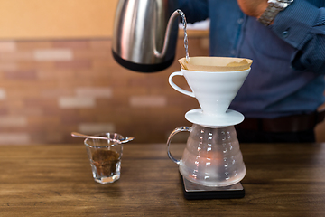 Image showing Barista making a drip coffee