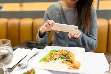 Image showing woman taking photo on her dishes