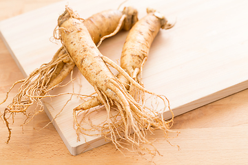 Image showing Fresh ginseng over wooden texture