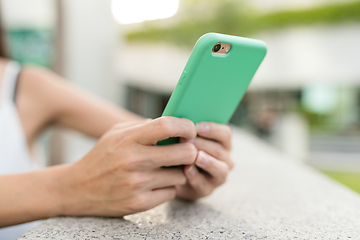 Image showing Woman using mobile phone in the street