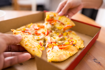 Image showing Woman taking one slice of pizza