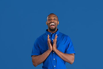 Image showing Monochrome portrait of young african-american man on blue studio background