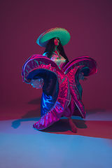 Image showing Fabulous Cinco de Mayo female dancer on purple studio background in neon light