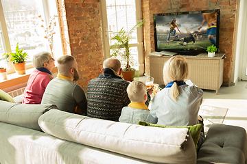 Image showing Excited family watching female football, sport match at home