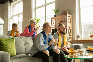 Image showing Excited family watching football, sport match at home, top view