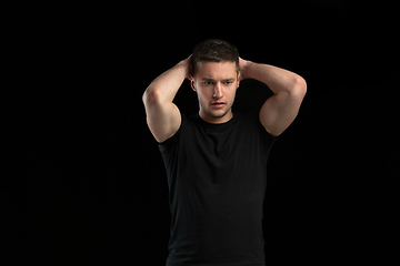 Image showing Monochrome portrait of young caucasian man on black studio background