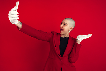 Image showing Portrait of young caucasian bald woman on red background