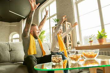 Image showing Excited family watching football, sport match at home, father and son