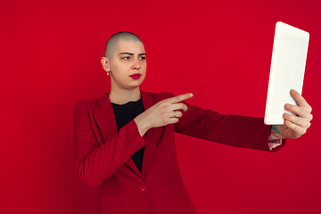 Image showing Portrait of young caucasian bald woman on red background