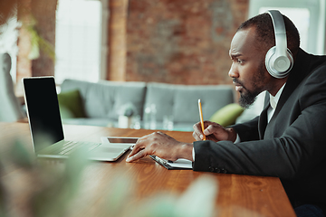 Image showing Businessman or student working from home while being isolated or keep quarantine \'cause of coronavirus COVID-19