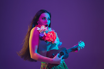 Image showing Fabulous Cinco de Mayo female dancer on purple studio background in neon light