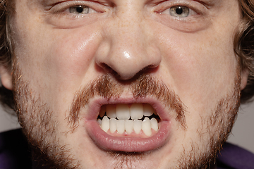 Image showing Close-up male mouth illustrating emotions. Cosmetology, dentistry and beauty care, facial expression